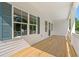 Exterior porch with wood decking, white railings, and large windows offering plenty of natural light at 2426 Park St., North Myrtle Beach, SC 29582