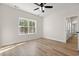 Cozy bedroom with a ceiling fan, wood-look floors, and a bright window offering an outdoor view at 2428 Park St., North Myrtle Beach, SC 29582