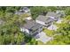 Three coastal homes featuring white exteriors, dark roofs, elevated design, and private driveways at 2428 Park St., North Myrtle Beach, SC 29582