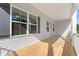 Covered porch with wood decking, white railings, and grey exterior at 2428 Park St., North Myrtle Beach, SC 29582
