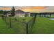 Scenic view of the fenced backyard with a swing set and access to a tranquil pond, perfect for families at 280 Macarthur Dr., Conway, SC 29527