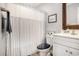 Cozy bathroom with a white vanity, a framed mirror, and a shower with a striped curtain, offering a clean, fresh design at 280 Macarthur Dr., Conway, SC 29527