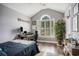 Comfortable bedroom with vaulted ceiling features a large window, wood-look floors and a cozy atmosphere at 280 Macarthur Dr., Conway, SC 29527