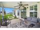 Relaxing covered patio featuring a ceiling fan, comfortable seating, and sliding glass doors to the house at 280 Macarthur Dr., Conway, SC 29527