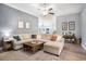 Spacious living room with a large sectional sofa, wood-look floors, and abundant natural light creates an inviting atmosphere at 280 Macarthur Dr., Conway, SC 29527