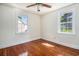 This bedroom features wood floors, a ceiling fan with lights, and two windows for lots of light at 320 Edgewood Circle, Conway, SC 29527