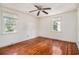 This bedroom features wood floors, a ceiling fan, and two windows for lots of natural light at 320 Edgewood Circle, Conway, SC 29527