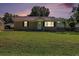 Charming single-story home with a well-manicured lawn and inviting front porch at dusk at 320 Edgewood Circle, Conway, SC 29527