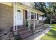 Inviting front porch featuring brick steps, white columns, and a view of the landscaped yard at 320 Edgewood Circle, Conway, SC 29527