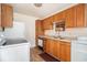 Functional kitchen with classic wood cabinets, white appliances, and linoleum flooring at 320 Edgewood Circle, Conway, SC 29527
