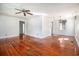 Spacious living room featuring hardwood floors, a ceiling fan, and fresh white walls at 320 Edgewood Circle, Conway, SC 29527