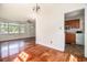 Open-concept living area leading to the kitchen with hardwood floors and bright natural light at 320 Edgewood Circle, Conway, SC 29527