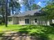 Rear exterior of the home featuring windows and sliding glass doors with a spacious yard at 3216 Hugo Rd., Conway, SC 29527