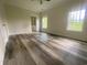 Bedroom with hardwood floors, two windows for natural light, and an ensuite bathroom at 3216 Hugo Rd., Conway, SC 29527