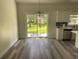 Dining area bathed in light, complemented by elegant flooring and a modern chandelier at 3216 Hugo Rd., Conway, SC 29527