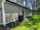 Side view of the home's exterior, showcasing the siding, utility access, and landscaping at 3216 Hugo Rd., Conway, SC 29527