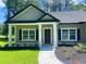 Charming front porch with white pillars and manicured landscaping leading to the front door at 3216 Hugo Rd., Conway, SC 29527