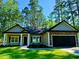 Inviting home featuring a well-manicured lawn and an attached two-car garage with a stone facade at 3216 Hugo Rd., Conway, SC 29527