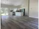 Open-concept kitchen with white cabinets, stainless appliances, and eat-in island with modern flooring at 3216 Hugo Rd., Conway, SC 29527