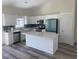 Bright kitchen features white cabinets, stainless steel appliances, and a center island at 3216 Hugo Rd., Conway, SC 29527