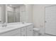 Bathroom featuring a double sink vanity, tiled shower, and a separate toilet room at 3217 Shadow Pine Ct., Myrtle Beach, SC 29579