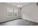 Well-lit dining area with hardwood floors, a contemporary chandelier, and large windows at 3217 Shadow Pine Ct., Myrtle Beach, SC 29579
