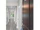 Bright hallway with modern gray floors, fresh paint, and a welcoming entrance door at 3217 Shadow Pine Ct., Myrtle Beach, SC 29579