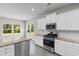 Bright kitchen with white cabinets, granite countertops, and stainless steel appliances at 3217 Shadow Pine Ct., Myrtle Beach, SC 29579