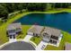 Lush aerial view highlighting homes located near a calm pond in a serene community at 326 Picnic Basket Pl., Longs, SC 29568