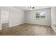 Bright bedroom with wood-look floors, a ceiling fan, and a large window for ample natural light at 326 Picnic Basket Pl., Longs, SC 29568