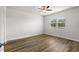 Bright bedroom with hardwood floors, a ceiling fan, and a window offering natural light at 326 Picnic Basket Pl., Longs, SC 29568