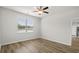 Modern bedroom with hardwood floors, a ceiling fan, and a view of the pond outside at 326 Picnic Basket Pl., Longs, SC 29568