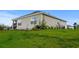 Exterior home view featuring vinyl siding, complemented by manicured green grass and garden beds at 326 Picnic Basket Pl., Longs, SC 29568