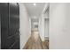 Bright hallway with light wood-look floors leading to the living area and bedrooms at 326 Picnic Basket Pl., Longs, SC 29568