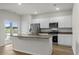 Modern kitchen with white cabinets, stainless steel appliances, and a granite countertop island at 326 Picnic Basket Pl., Longs, SC 29568