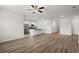 Large living area with wood-look floors, a ceiling fan, and an open layout leading to the kitchen at 326 Picnic Basket Pl., Longs, SC 29568