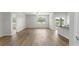 Open-concept living room with wood-look floors, ceiling fan, and view into the dining and kitchen areas at 326 Picnic Basket Pl., Longs, SC 29568