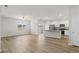 Inviting living room that flows into the kitchen, featuring wood-look floors and recessed lighting at 326 Picnic Basket Pl., Longs, SC 29568