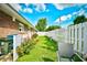 The well-maintained backyard features a white fence, lush green lawn, and space for outdoor seating at 3602 Magnolia St. # 3602, Myrtle Beach, SC 29577