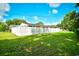 A lovely fenced backyard with beautiful green grass beneath a bright blue sky at 3602 Magnolia St. # 3602, Myrtle Beach, SC 29577
