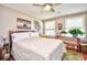 This bedroom features a comfortable bed with stylish decor, a ceiling fan, and a sunlit window at 3602 Magnolia St. # 3602, Myrtle Beach, SC 29577