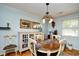 Cozy dining area with a round table, four chairs, and elegant lighting fixture at 3602 Magnolia St. # 3602, Myrtle Beach, SC 29577