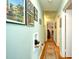 Hallway featuring hardwood floors with a patterned rug and blue accent walls at 3602 Magnolia St. # 3602, Myrtle Beach, SC 29577