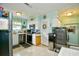 Well-lit kitchen featuring white cabinets, stainless steel appliances, and a modern water dispenser at 3602 Magnolia St. # 3602, Myrtle Beach, SC 29577