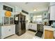 Bright kitchen features white cabinets, stainless steel appliances, and unique decor for a cozy feel at 3602 Magnolia St. # 3602, Myrtle Beach, SC 29577