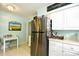 Bright kitchen with stainless steel refrigerator, white cabinets, and adjacent breakfast table at 3602 Magnolia St. # 3602, Myrtle Beach, SC 29577
