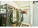 This laundry room boasts modern appliances, including a washer and dryer, with ample cabinet storage at 3602 Magnolia St. # 3602, Myrtle Beach, SC 29577