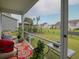 View from the screened in porch showing a landscaped backyard, gazebo, and neighboring houses at 376 Mikita Dr., Surfside Beach, SC 29575