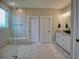Bathroom featuring walk-in shower with built-in bench, dual vanities, and neutral color palette at 376 Mikita Dr., Surfside Beach, SC 29575