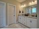 Bathroom featuring walk-in shower, dual vanities, and large mirror at 376 Mikita Dr., Surfside Beach, SC 29575
